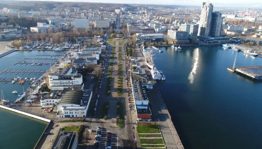 Widok z lotu ptaka na Skwer Kościuszki w Gdyni z mariną, statkami i nowoczesną architekturą.